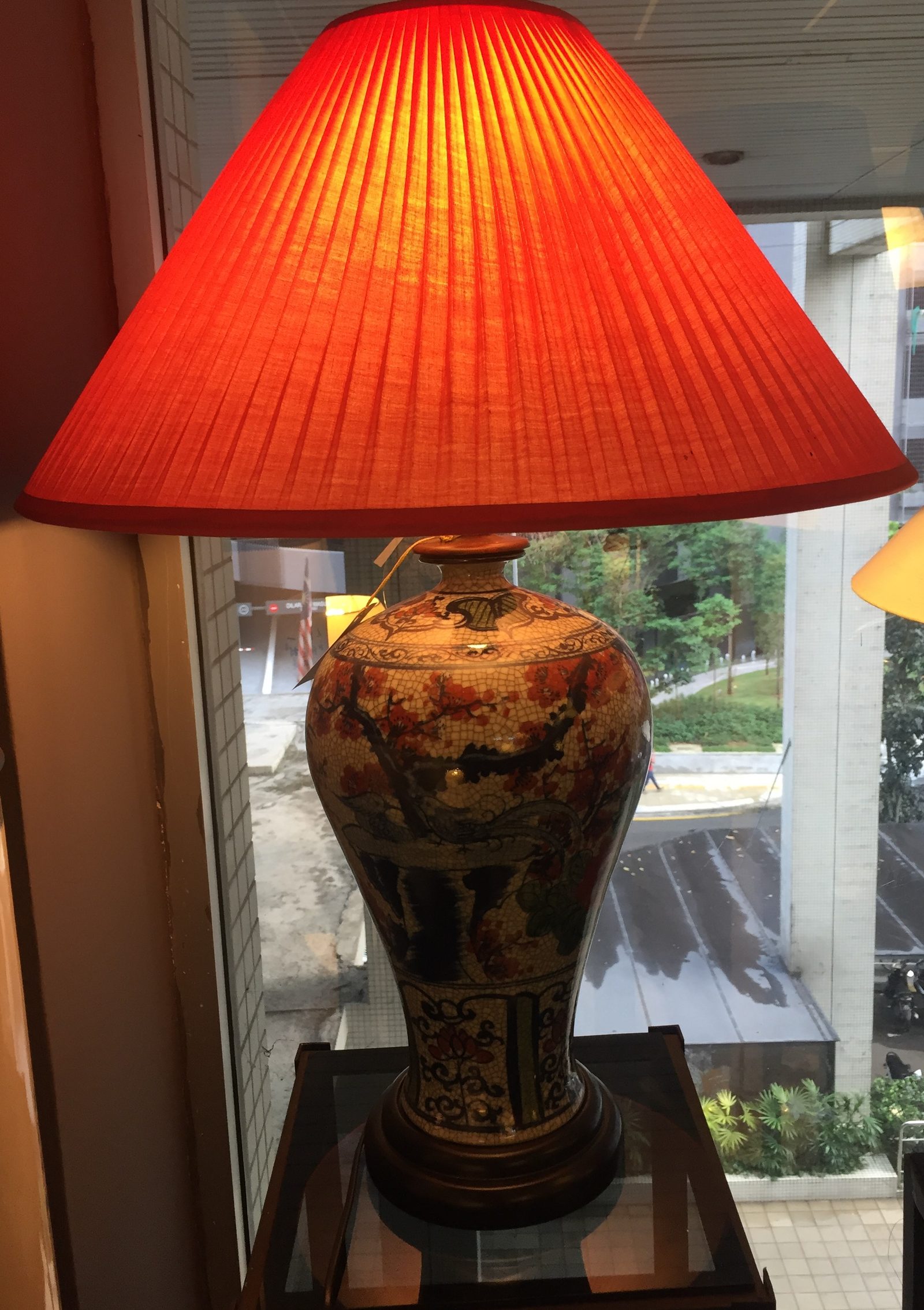 Table lamp with a tall warm orange fabric shade